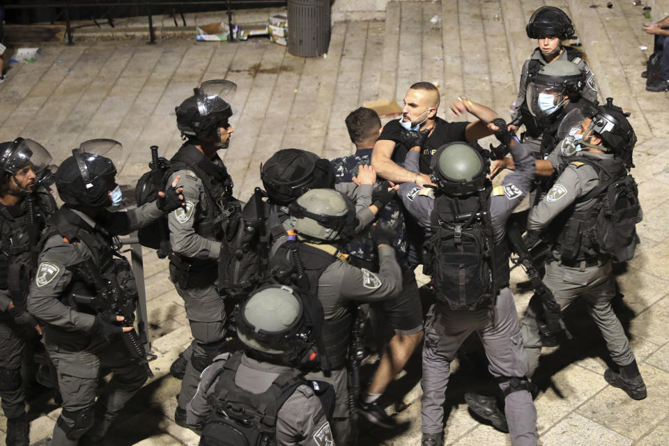 Israeli police forcibly detain a Palestinian outside of the Damascus Gate to the Old City of Jerusalem Tuesday, May 11, 2021. A confrontation between Israel and Hamas sparked by weeks of tensions in contested Jerusalem escalated Tuesday as Israel unleashed new airstrikes on Gaza while militants barraged Israel with hundreds of rockets. (AP Photo/Mahmoud Illean)