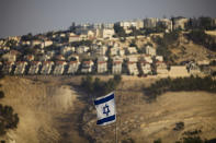 FILE - In this Monday, Sept. 7, 2009 file photo, an Israeli flag is seen in front of the West Bank Jewish settlement of Maaleh Adumim, on the outskirts of Jerusalem. Nine months of U.S.-driven diplomacy have left Israelis and Palestinians less hopeful than ever about a comprehensive peace agreement to end their century of conflict. Although a formula may yet be found to somehow prolong the talks past an end-of-April deadline, they are on the brink of collapse and the search is already on for new ideas. (AP Photo/Bernat Armangue, File)