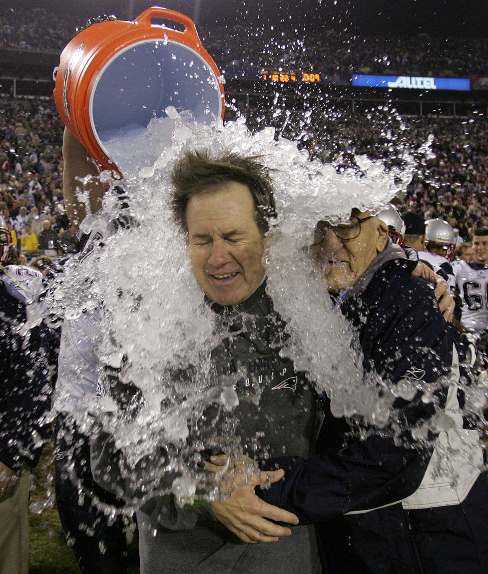 FILE - New England Patriots head coach Bill Belichick is doused after the Patriots beat the Philadelphia Eagles 24-21 in Super Bowl XXXIX at Alltel Stadium in Jacksonville, Fla., Feb. 6, 2005. At right is Belichick's father, Steve. Six-time NFL champion Bill Belichick has agreed to part ways as the coach of the New England Patriots on Thursday, Jan. 11, 2024, bringing an end to his 24-year tenure as the architect of the most decorated dynasty of the league’s Super Bowl era, a source told the Associated Press on the condition of anonymity because it has not yet been announced.(AP Photo/David J. Phillip, File)