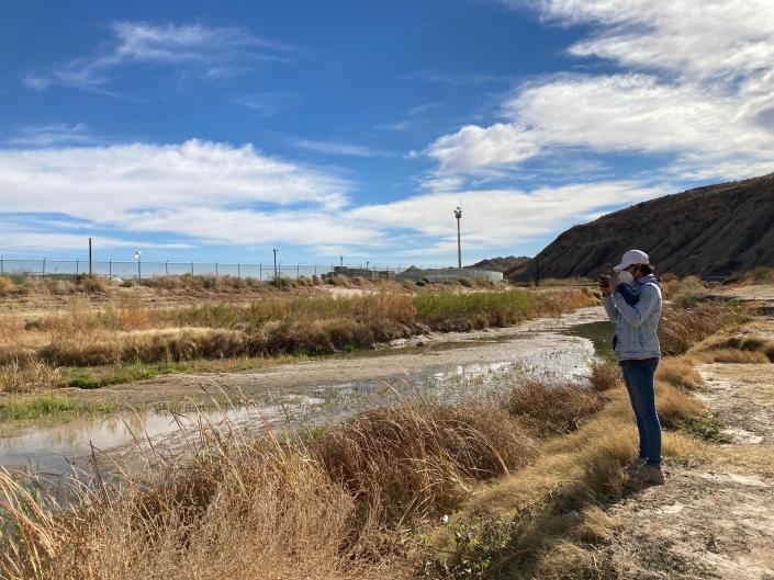 Raymundo Aguilar, of the Defensa de la Sierra de Ciudad Ju&#xe1;rez collective, documents the wastewater discharge into the Rio Grande on Dec. 28, 2021.