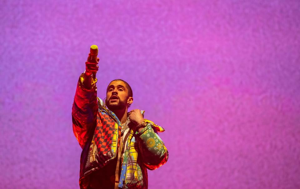 Headliner Bad Bunny holds the microphone out to the crowd to have them sing along to "Tití Me Preguntó" during his set on the Coachella Stage during the Coachella Valley Music and Arts Festival at the Empire Polo Club in Indio, Calif., Friday, April 14, 2023.