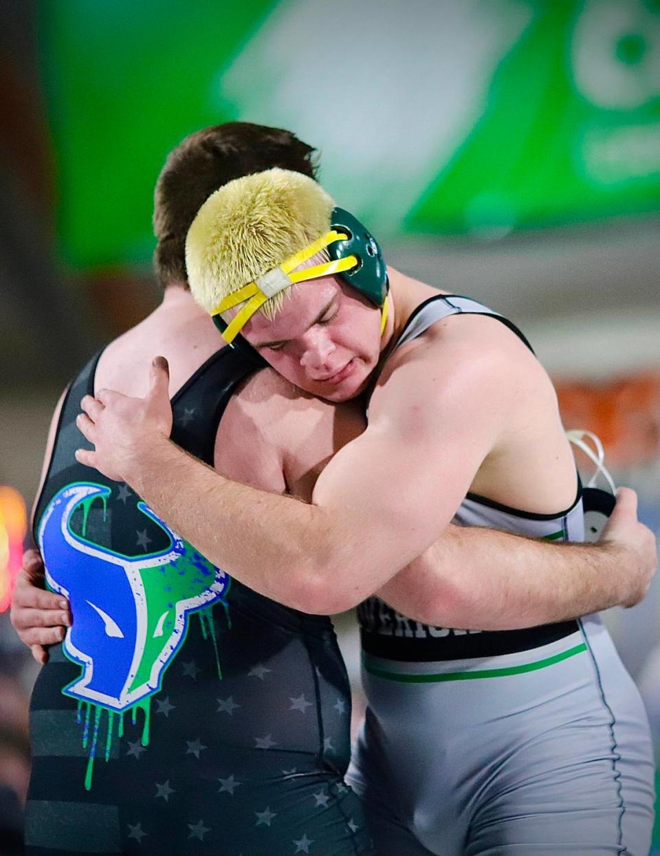 Mountain View teammates and longtime wrestling partners Shiloh Jones (facing) and Aiden McGinnis share a hug after their heavyweight championship about at the ICCU Dome in Pocatello.