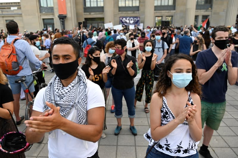 People attend a vigil in memory of a Muslim family in Montreal