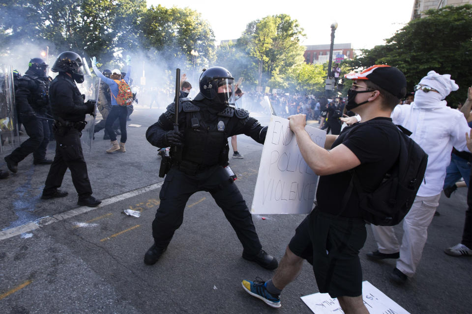 Police officers clash with protestors