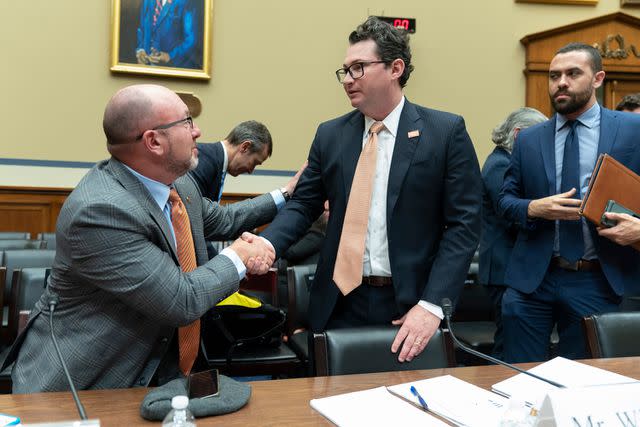 <p>Manuel Balce Ceneta/AP Photo</p> Rob Wilcox (right) shakes hands with a fellow witness after a House hearing in March 2023