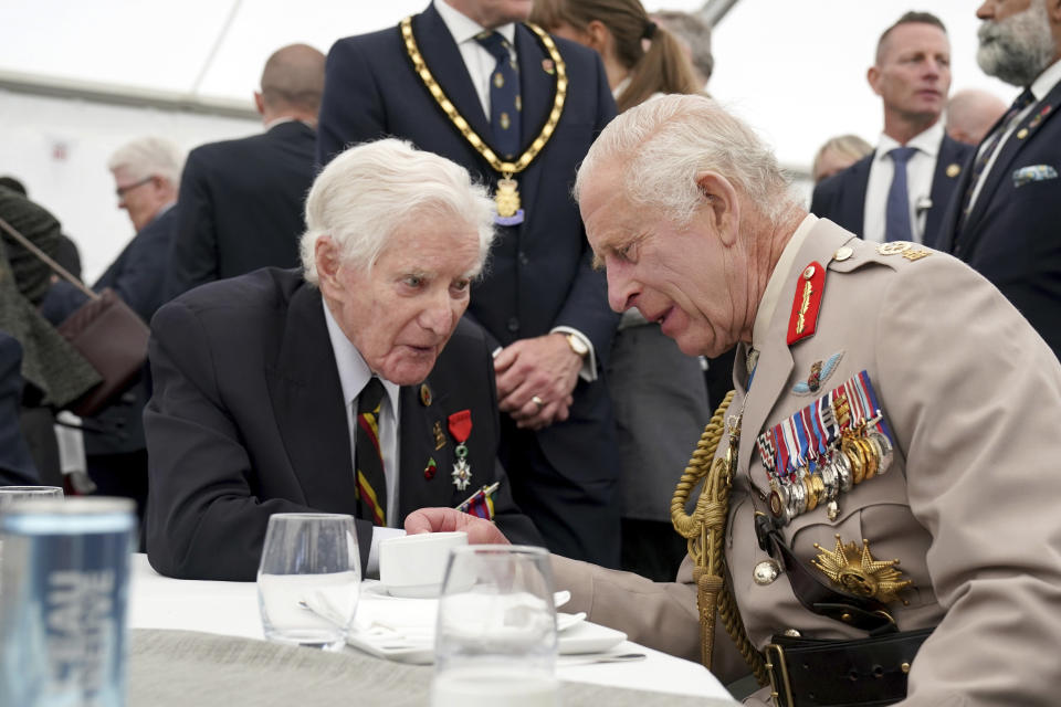 King Charles III speaks to a D-Day veteran during a lunch following the UK national commemorative event for the 80th anniversary of D-Day, held at the British Normandy Memorial in Ver-sur-Mer, Normandy, France, Thursday June 6, 2024. (Gareth Fuller, Pool Photo via AP)