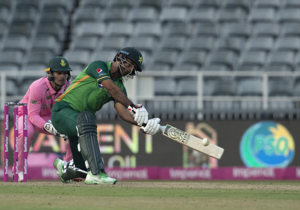 Pakistan's batsman Fakhar Zaman, right, plays a shot as South Africa's wicketkeeper Quinton de Kock watches on during the second One Day International cricket match between South Africa and Pakistan at the Wanderers stadium in Johannesburg, South Africa, Sunday, April 4, 2021. (AP Photo/Themba Hadebe)