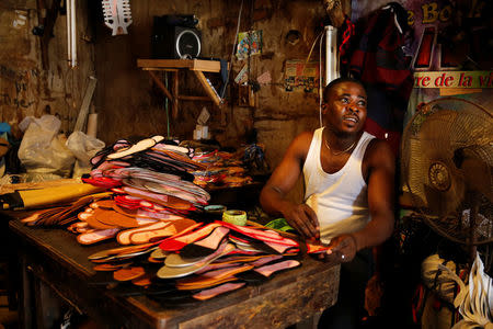 A man works on footwear in Araria market in Aba, Nigeria August 19, 2016. REUTERS/Afolabi Sotunde