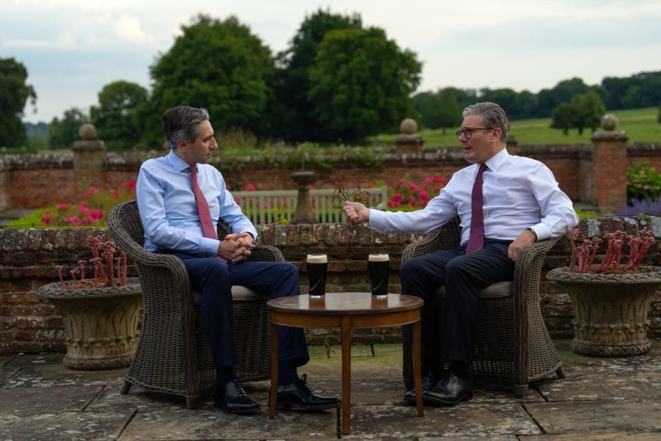 Keir Starmer and Irish prime minister Simon Harris drink a pint of Guinness during a meeting at Chequers on Wednesday (PA)