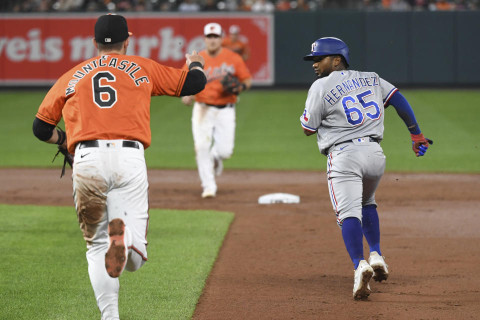 Texas Rangers' Yonny Hernandez (65) is picked off by Baltimore Orioles starting pitcher Chris Ellis and caught stealing by shortstop Pat Valaika during the second inning of a baseball game Saturday, Sept. 25, 2021, in Baltimore. (AP Photo/Terrance Williams)