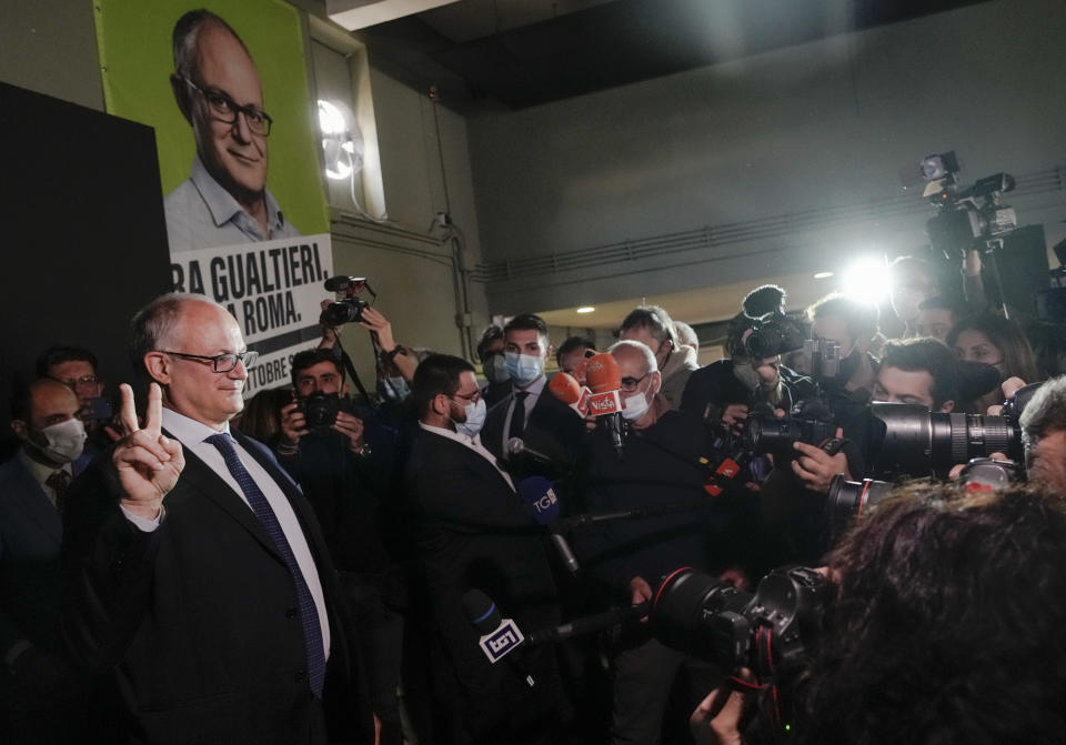 Center-left mayoral candidate Roberto Gualtieri flashes a v-sign at his party's headquarters in Rome, Monday, Oct. 18, 2021. Romans are waiting to learn who will be their next mayor, following runoff elections that ended Monday in the Italian capital. The top vote-getters in the first round of balloting two weeks earlier, Enrico Michetti, a novice politician backed by a far-right leader, and Roberto Gualtieri, a Democrat and former finance minister, competed in the runoff Sunday and Monday. (AP Photo/Gregorio Borgia)