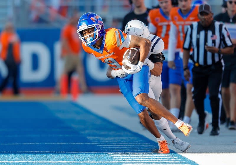 Boise State wide receiver Cameron Camper (9) is pulled out of bounds by Utah State safety Jordan Vincent (24) after a reception in the first half of an NCAA college football game, Saturday, Oct. 5, 2024, in Boise, Idaho. . (AP Photo/Steve Conner) | Steve Conner