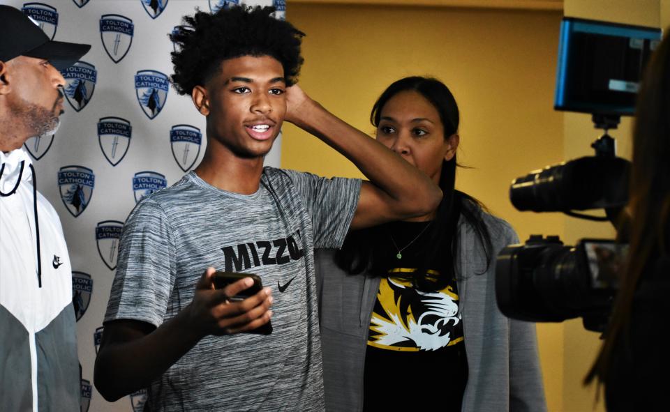 Aaron Rowe stands after finishing media interviews following his commitment to the University of Missouri after a commitment ceremony at Tolton Catholic High School on Dec. 12, 2023, in Columbia, Mo.