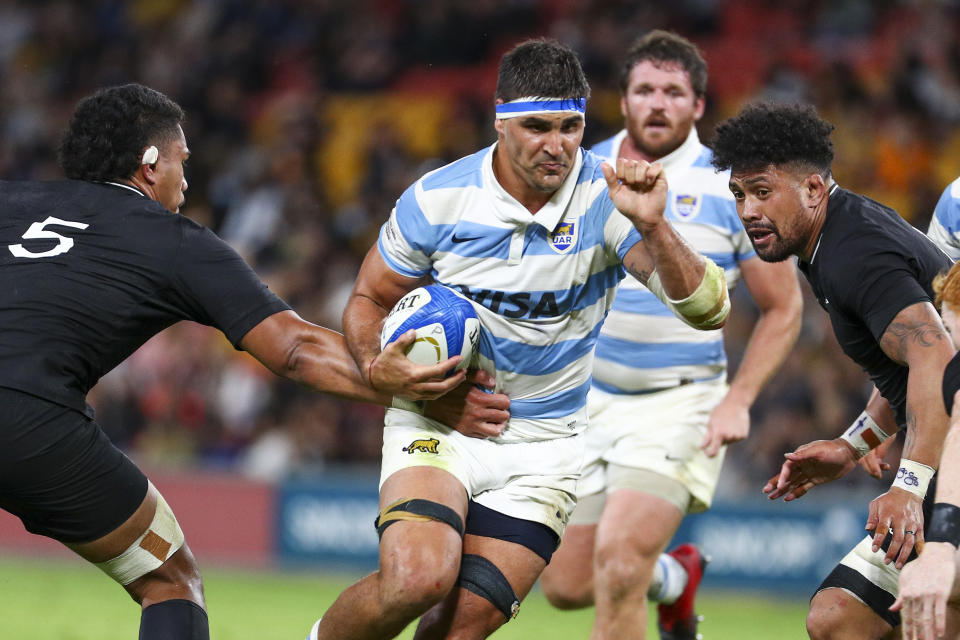 Argentina's Pablo Matera, centre, runs at New Zealand's Tupou Vaa'i, left, and Ardie Savea during the Rugby Championship test match between the All Blacks and the Pumas in Brisbane, Australia, Saturday, Sept. 18, 2021. (AP Photo/Tertius Pickard)