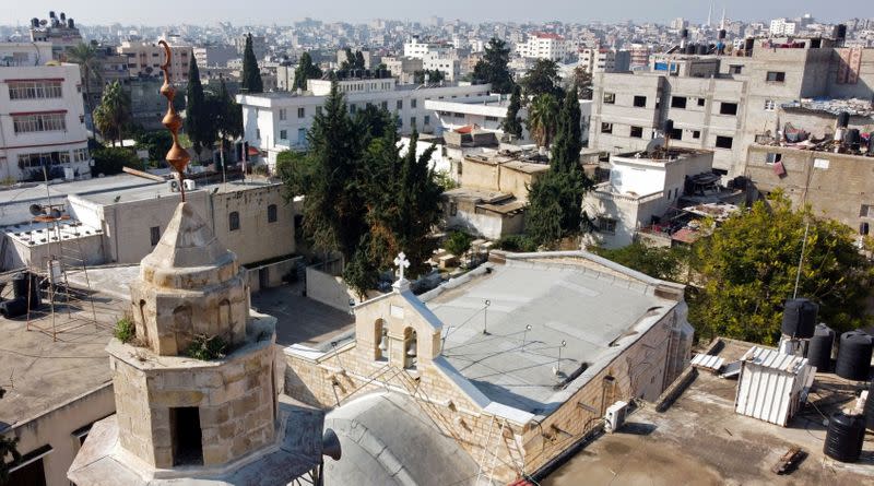 A picture taken with a drone shows the minaret of a mosque and the exterior of the Saint Porfirios church in Gaza City