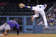 Colorado Rockies' Ryan McMahon, left, steals second as Los Angeles Dodgers second baseman Gavin Lux attempts a late tag during the seventh inning of a baseball game Tuesday, July 5, 2022, in Los Angeles. (AP Photo/Mark J. Terrill)