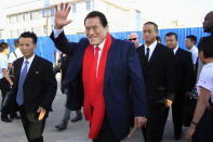 CORRECTS TO 1976, NOT 1979 - FILE - Japanese pro-wrestler turned politician Kanji "Antonio" Inoki waves as he arrives at the Sunan International Airport on Aug. 28, 2014, in Pyongyang, North Korea. A popular Japanese professional wrestler and lawmaker Antonio Inoki, who faced a world boxing champion Muhammad Ali in a mixed martial arts match in 1976, has died at 79. The New Japan Pro-Wrestling Co. says Inoki, who was battling an illness, died earlier Saturday, Oct. 1, 2022. (AP Photo/Jon Chol Jin, File)