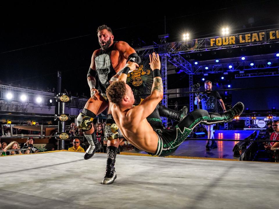 Wrestlers in a wrestling ring surrounded by a crowd on a Sixthman cruise