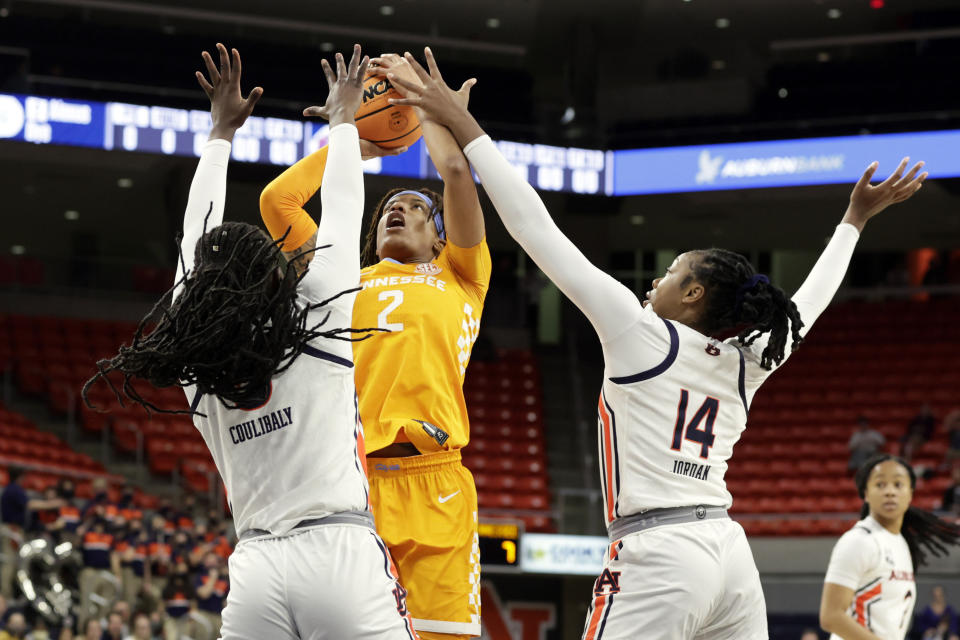 Tennessee forward Alexus Dye (2) shoots over Auburn guard Aicha Coulibaly (5) and forward Jala Jordan (14) during the first half of an NCAA college basketball game Thursday, Jan. 27, 2022, in Auburn, Ala. (AP Photo/Butch Dill)