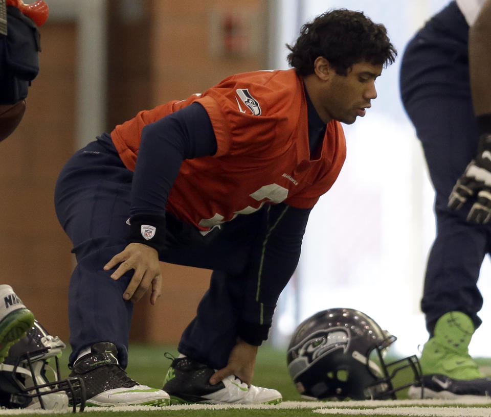 Seattle Seahawks quarterback Russell Wilson stretches at the start of NFL football practice Thursday, Jan. 30, 2014, in East Rutherford, N.J. The Seahawks and the Denver Broncos are scheduled to play in the Super Bowl XLVIII football game Sunday, Feb. 2, 2014. (AP Photo)