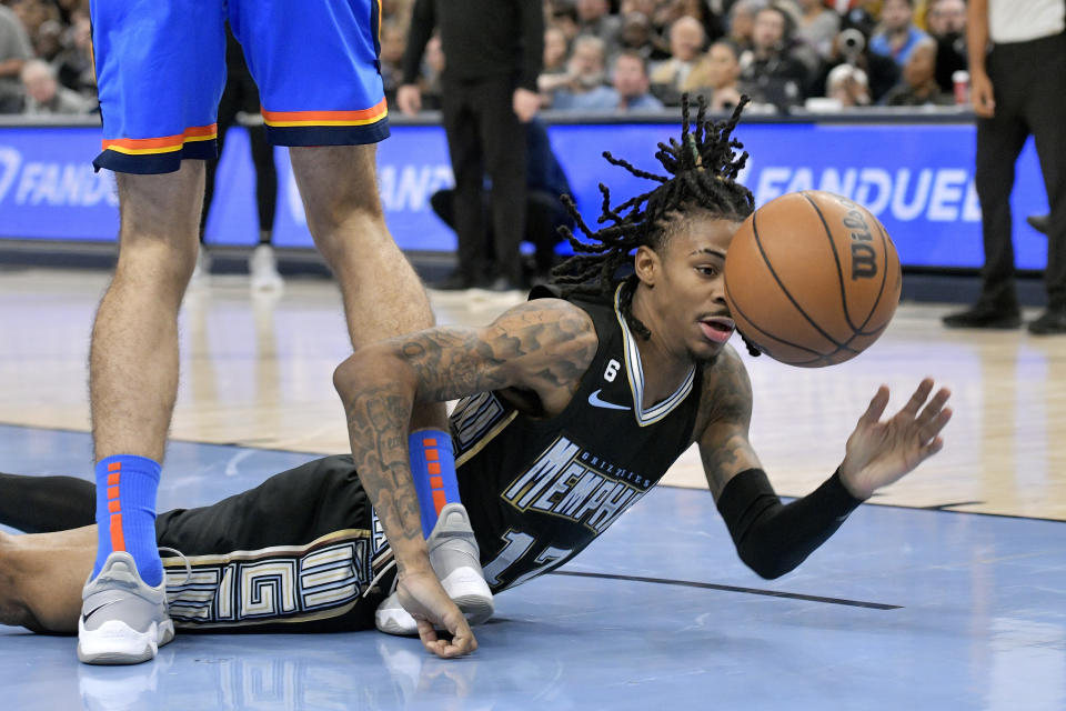 Memphis Grizzlies guard Ja Morant falls to the court in the first half of the team's NBA basketball game against the Oklahoma City Thunder on Friday, Nov. 18, 2022, in Memphis, Tenn. (AP Photo/Brandon Dill)