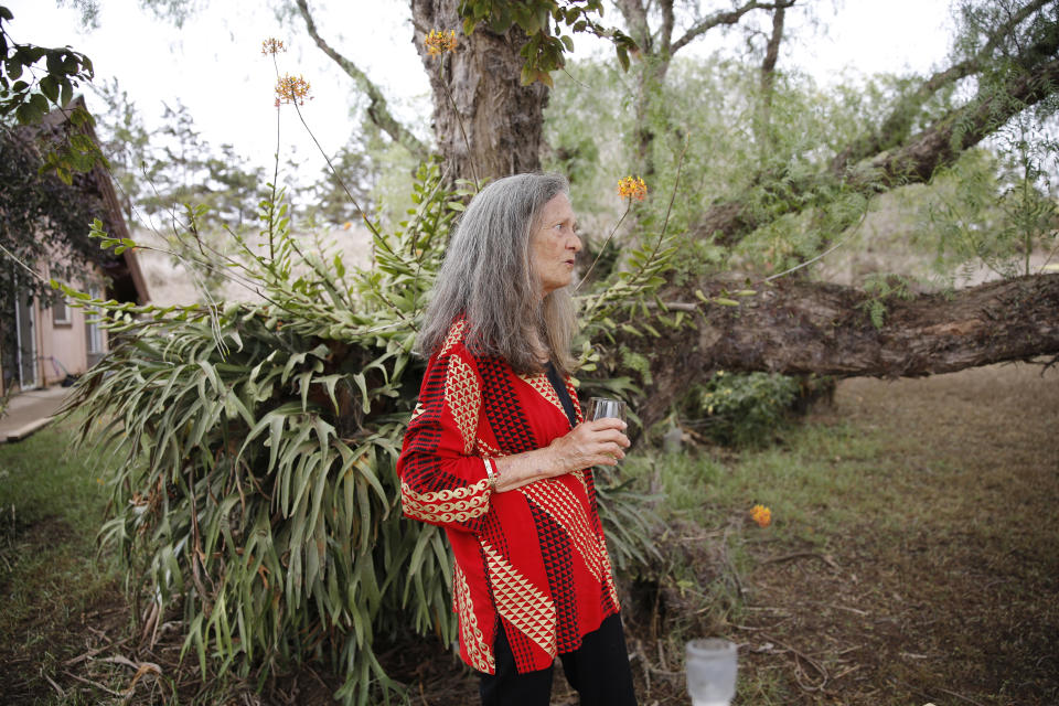 Native Hawaiian Mikiala Brand stands on her homestead property near Waimea, Hawaii, Wednesday, Aug. 4, 2021. Brand's home narrowly escaped the state's largest-ever wildfire. (AP Photo/Caleb Jones)