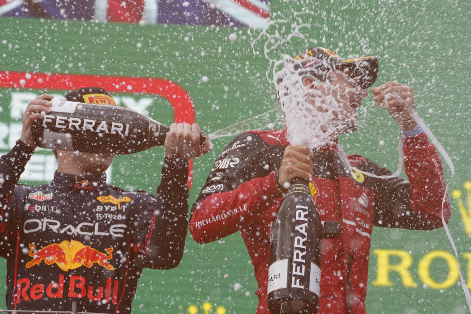 Ferrari driver Charles Leclerc, right, of Monaco, celebrates on the podium with second placed Red Bull driver Max Verstappen, of the Netherlands, after winning the Austrian F1 Grand Prix at the Red Bull Ring racetrack in Spielberg, Austria, Sunday, July 10, 2022. (AP Photo/Matthias Schrader)