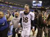 FILE - Denver Broncos quarterback Peyton Manning (18) walks off the field after an NFL football game against the Indianapolis Colts in Indianapolis, in this Sunday, Oct. 20, 2013, in Indianapolis. The Colts won 39-33. After five straight victories to open the season with his new team, the Broncos, Manning was on his way to his record fifth MVP award while setting all sorts of league passing marks. The matchup with the Colts in Indianapolis was ballyhooed like the second coming, but despite Manning's brilliance _ three touchdown passes, 386 yards in the air _ his replacement, Andrew Luck, got the win 39-33. “I am kind of relieved in some ways that this game is over,” he said at the end of a long night. (AP Photo/Michael Conroy, File)