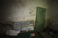 Markings are shown made by children and adults in the basement of a school which was used as a bomb shelter for children and their parents, as their village was being attacked by Russian strikes, in Yahidne village, northern Chernihiv region, Ukraine, Wednesday, June 29, 2022. A few months after Russian troops retreated from Yahidne in the northern Chernihiv region, the village has gradually returned to life. No one in the village yet plans to rebuild the school; they prefer not to mention the place at all. Most of Yahidne's residents — almost 400 people — spent a month in the school's basement. (AP Photo/Nariman El-Mofty)