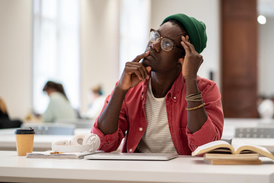 black man looking up, lost in thought