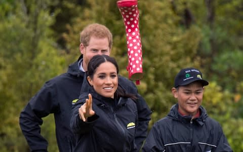 Meghan, Duchess of Sussex competes in a welly boot throwing competition in Auckland - Credit: PA