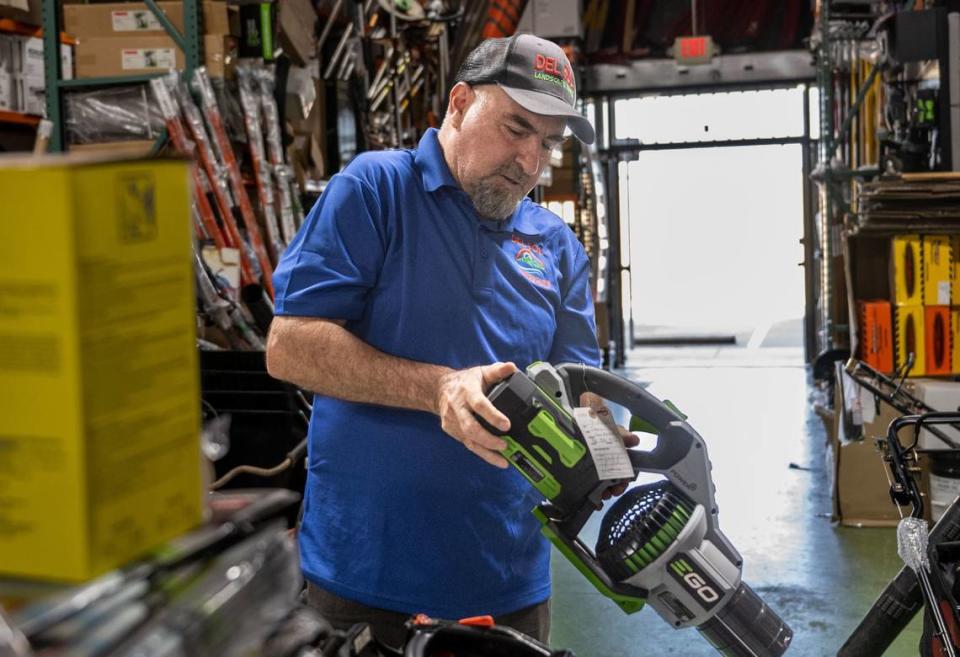 Fulgencio Vazquez, owner of Del Sol Landscape Power Tools, tests an electric blower in August that was repaired in his Sacramento store. Vazquez said that he feels the landscape industry will have a hard time transitioning from gas to battery-powered electric tools because of the amount of time they operate the equipment. The cost of batteries is high and landscapers would need to purchase extra batteries for an eight-hour work day.