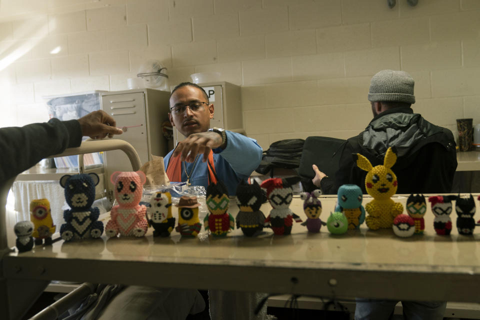 Prisoner Gabriel Aquila shows a collection of 3D origami figures he made at Valley State Prison in Chowchilla, Calif., Friday, Nov. 4, 2022. In a nation that incarcerates roughly 2 million people, the COVID pandemic was a nightmare for prisons. Overcrowding, subpar medical care and the ebb and flow of prison populations left most places unprepared to handle the spread of the highly contagious virus. (AP Photo/Jae C. Hong)