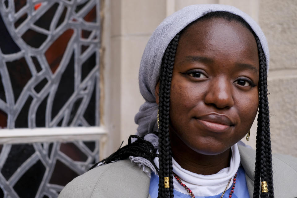 Nathalie Charles poses for a portrait outside the Princeton University Chapel in Princeton, N.J. on Wednesday, Dec. 8, 2021. Charles left her Baptist church at the age of 15 because as a queer woman of Haitian descent, she felt unwelcome in her congregation, with its conservative views on immigration, gender and sexuality. The 18-year-old freshman at Princeton has since identified as atheist, and then agnostic, before embracing a spiritual but not religious life. (AP Photo/Luis Andres Henao)