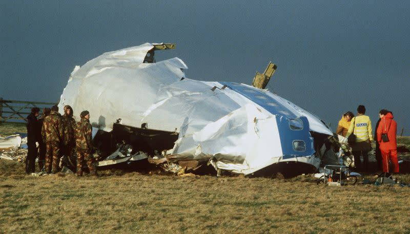 FILE PHOTO: Scottish rescue workers and crash investigators search the area around the cockpit of Pan Am flight 103 in a farmer's field east of Lockerbie