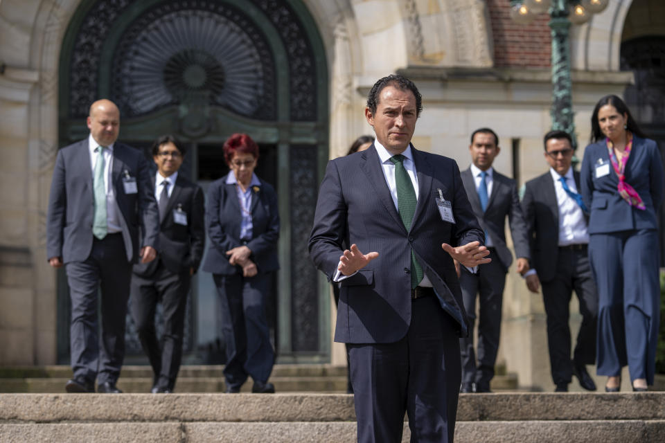 Mexico's legal advisor Alejandro Celorio Alcantar, gesturing, and members of the Mexican delegation gave a brief statement outside the International Court of Justice in The Hague, Netherlands, Tuesday, April 30, 2024. Mexico took Ecuador to the top U.N. court Tuesday, accusing the nation of violating international law by storming the Mexican Embassy in Quito to arrest Jorge Glas, a former vice president who had just been granted asylum by Mexico. (AP Photo/Peter Dejong)