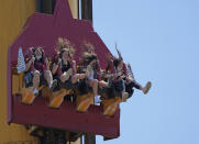 People enjoy a ride at Cinecitta World amusement park in the outskirts of Rome in the day of its reopening, Thursday, June 17, 2021. Amusement parks have been closed since Oct. 25 2020, when Italy's second national lockdown started. (AP Photo/Alessandra Tarantino)