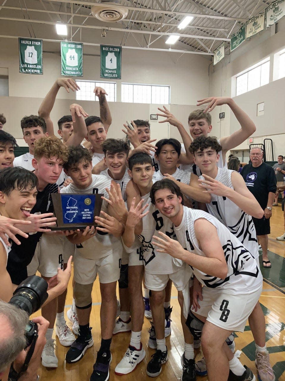 The Old Bridge volleyball team celebrates after winning the 2022 NJSIAA Central championship