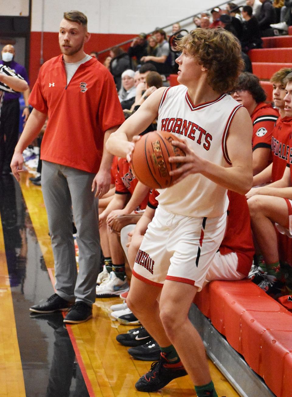 Honesdale's Peter Modrovsky prepares to unleash a long inbounds pass while rookie skipper Jon Gillow looks on. The Hornets presented Coach Gillow with his very first varsity win this week at the Jaycees Holiday Tournament.