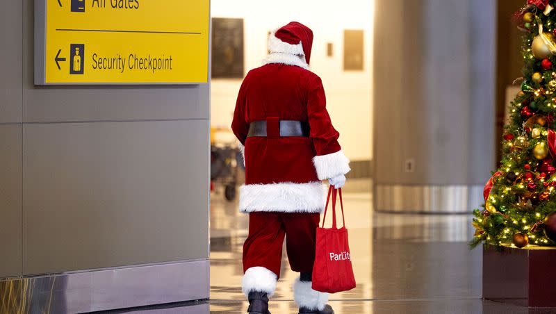 Santa Claus walks through Salt Lake City International Airport on Monday, Dec. 18, 2023.