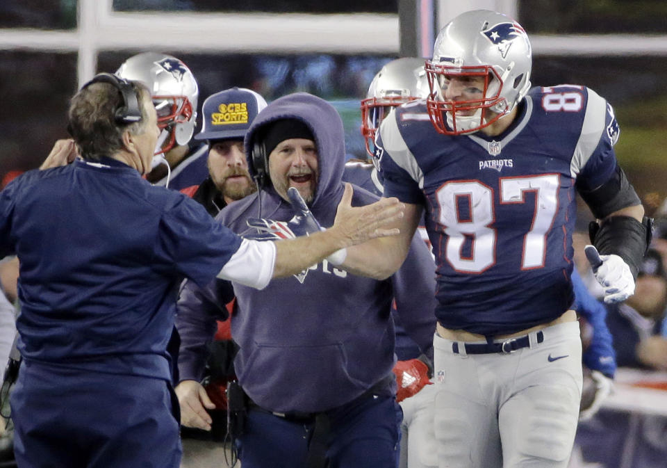 New England Patriots head coach Bill Belichick congratulates tight end Rob Gronkowski (87) after his touchdown catch against the Kansas City Chiefs in the second half of an NFL divisional playoff football game, Saturday, Jan. 16, 2016, in Foxborough, Mass. (AP Photo/Elise Amendola)