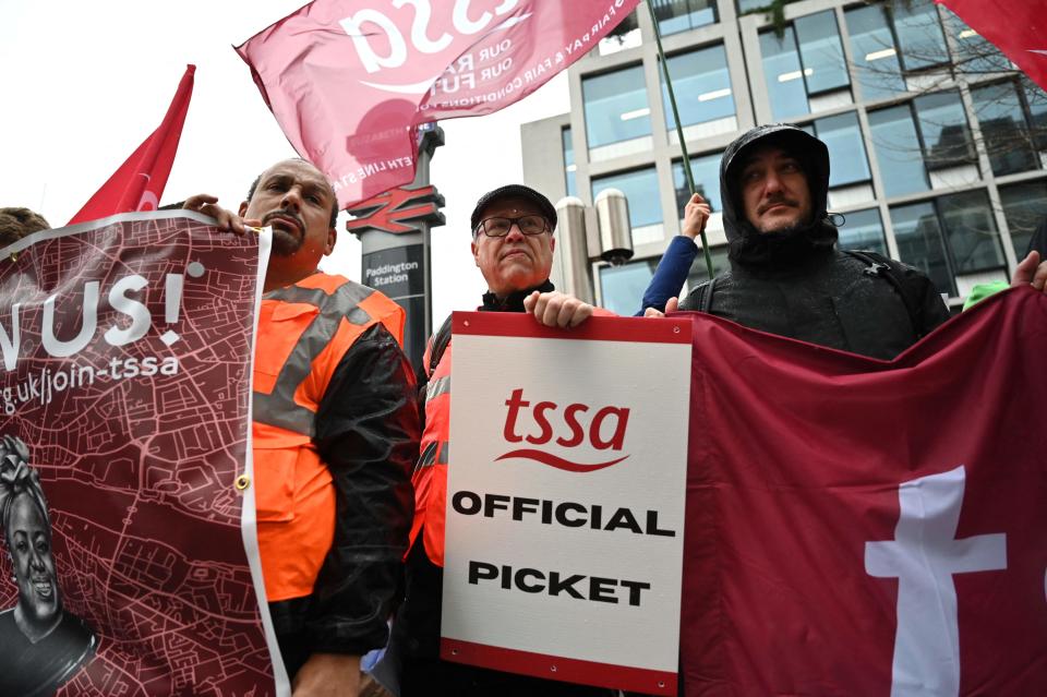 Elizabeth Line workers hold signs at a picket line (AFP via Getty Images)