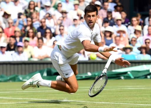 'Rubber man': Novak Djokovic dives for a return