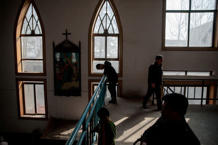 FILE PHOTO: Believers pray at the government-sanctioned Catholic church during a mass on Palm Sunday in Youtong village, Hebei province, China, March 25, 2018. REUTERS/Damir Sagolj/File Photo