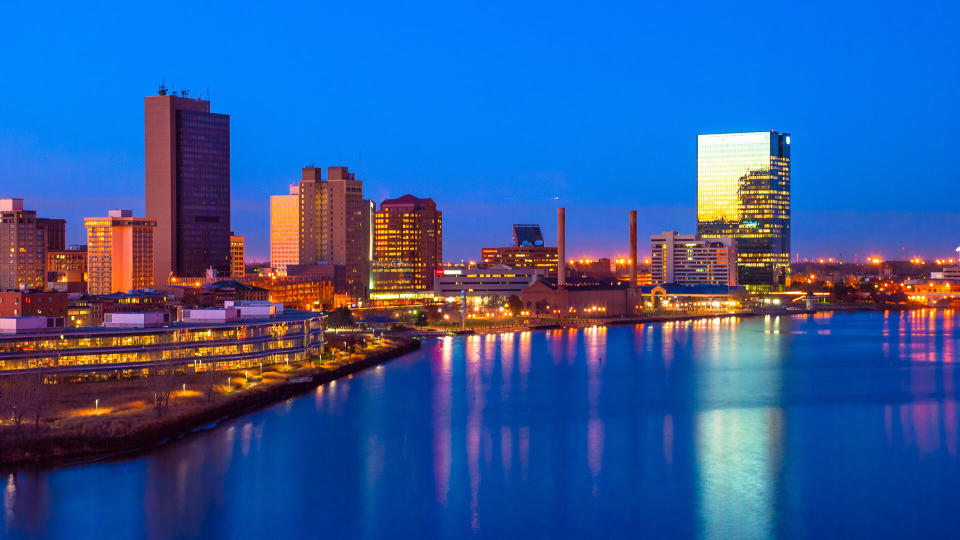 Downtown Toledo skyline and Maumee River aerial / elevated view at dusk with sunset reflections.