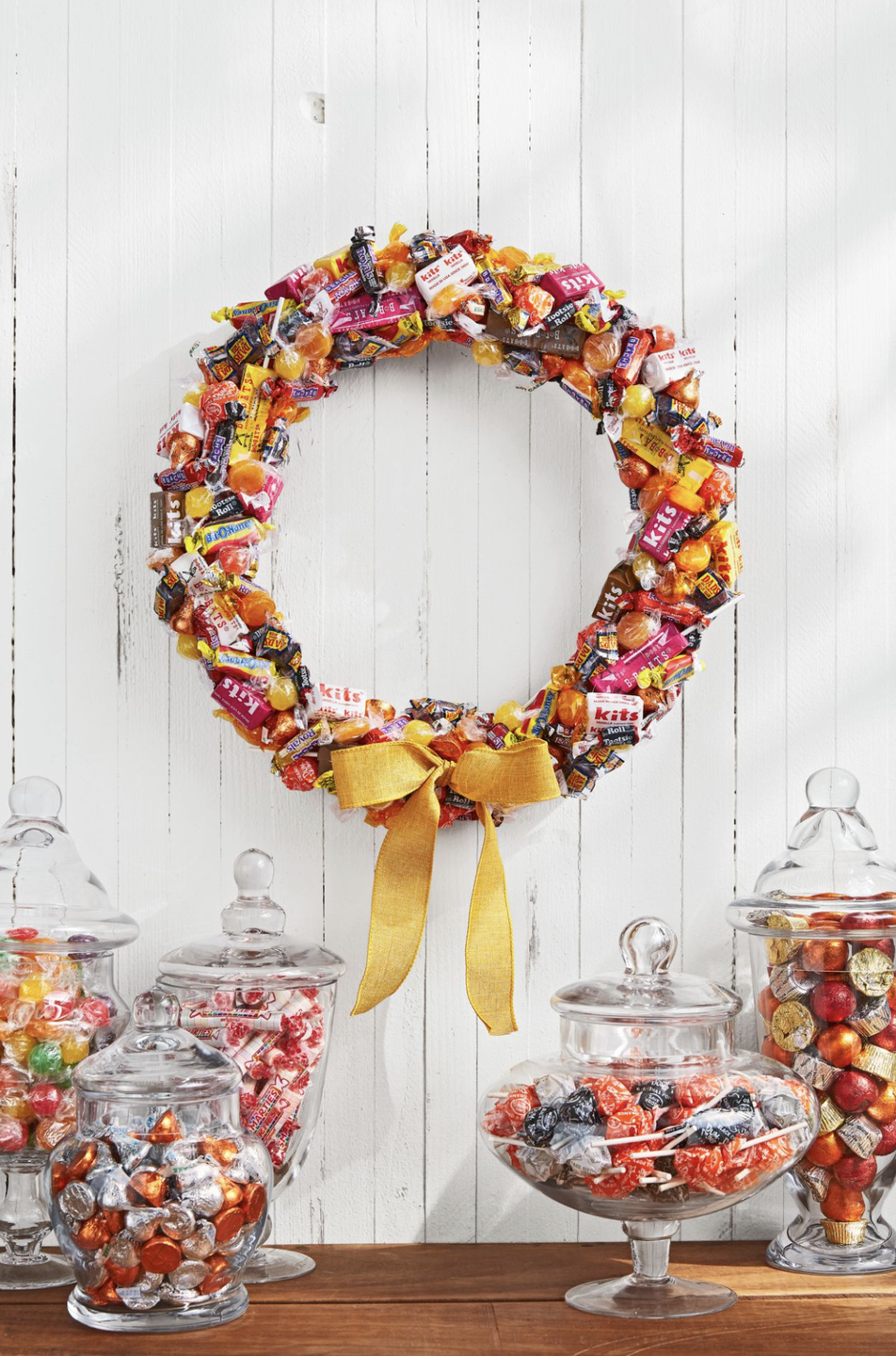 wreath made of assorted mini halloween candies and a yellow bow