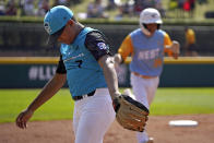 Honolulu's Kama Angell, right. rounds third past Curacao's Jay-Dlynn Wiel (7) after hitting a solo home run during the first inning of the Little League World Series Championship game in South Williamsport, Pa., Sunday, Aug. 28, 2022. (AP Photo/Gene J. Puskar)