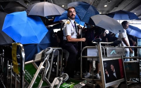 Hundreds of Hong Kong pro-democracy activists attempted to block transport routes to the city's airport  - Credit: LILLIAN SUWANRUMPHA/AFP/Getty Images