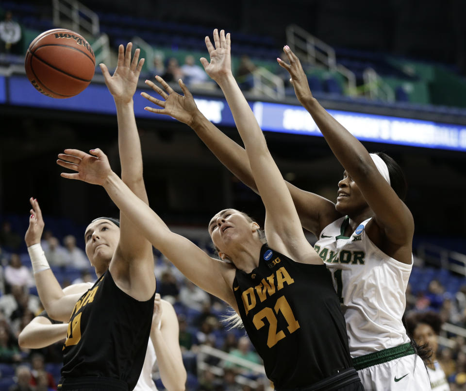 Baylor's Kalani Brown, right, battles Iowa's Hannah Stewart, center, and Megan Gustafson, left, during the first half of a regional final women's college basketball game in the NCAA Tournament in Greensboro, N.C., Monday, April 1, 2019. (AP Photo/Gerry Broome)