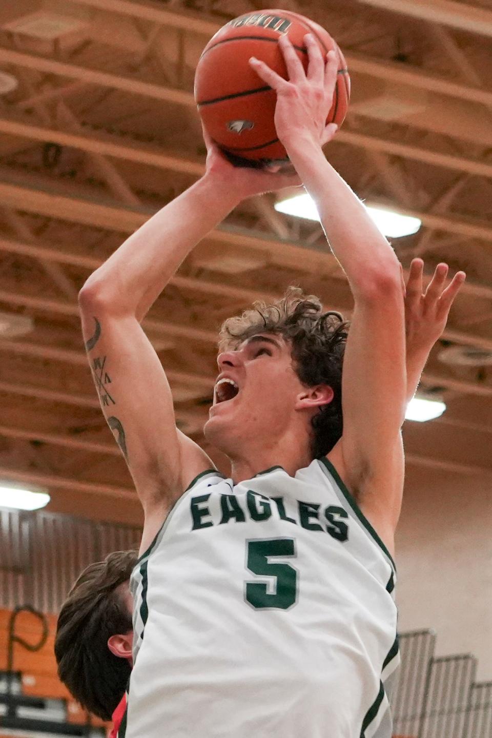Zionsville Eagles Maguire Mitchell (5) scores a layup Tuesday, Feb. 6, 2024, during the game at Zionsville High School in Zionsville, Indiana. The Center Grove Trojans defeated the Zionsville Eagles 60-49.